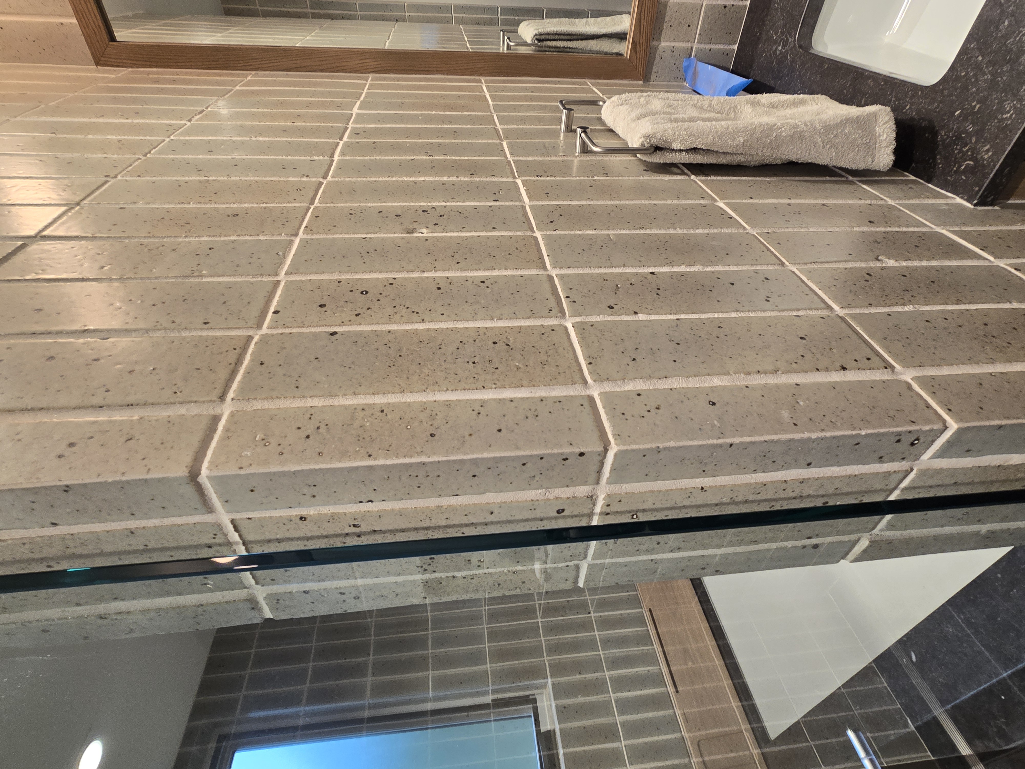 Close-up of precision outside corner miter tile work on shower surround